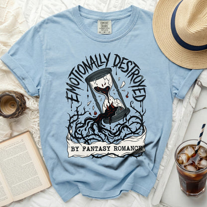 Light blue t-shirt with cracked hourglass and text "Emotionally Destroyed By Fantasy Romance".