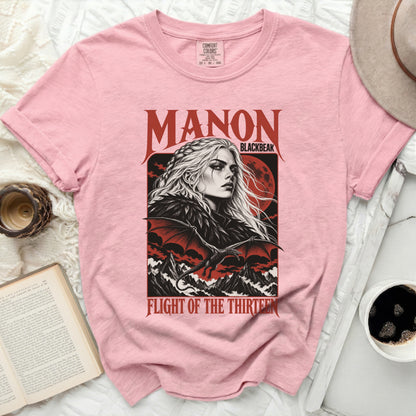 Pink t-shirt with black graphic of "Manon Blackbeak" and a dragon.