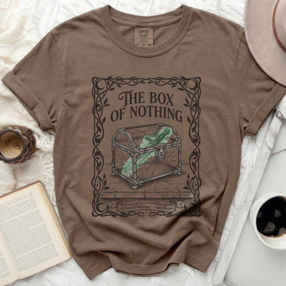 Brown t-shirt with "The Box of Nothing" graphic and book page.