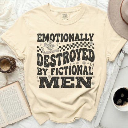 Cream t-shirt with black graphic text "EMOTIONALLY DESTROYED BY FICTIONAL MEN."