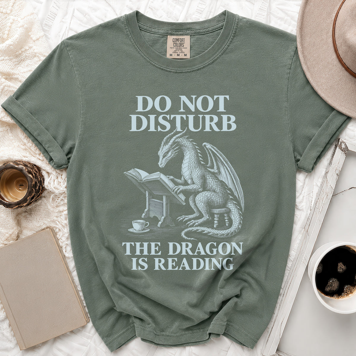 Green t-shirt with dragon reading text: "DO NOT DISTURB THE DRAGON IS READING."