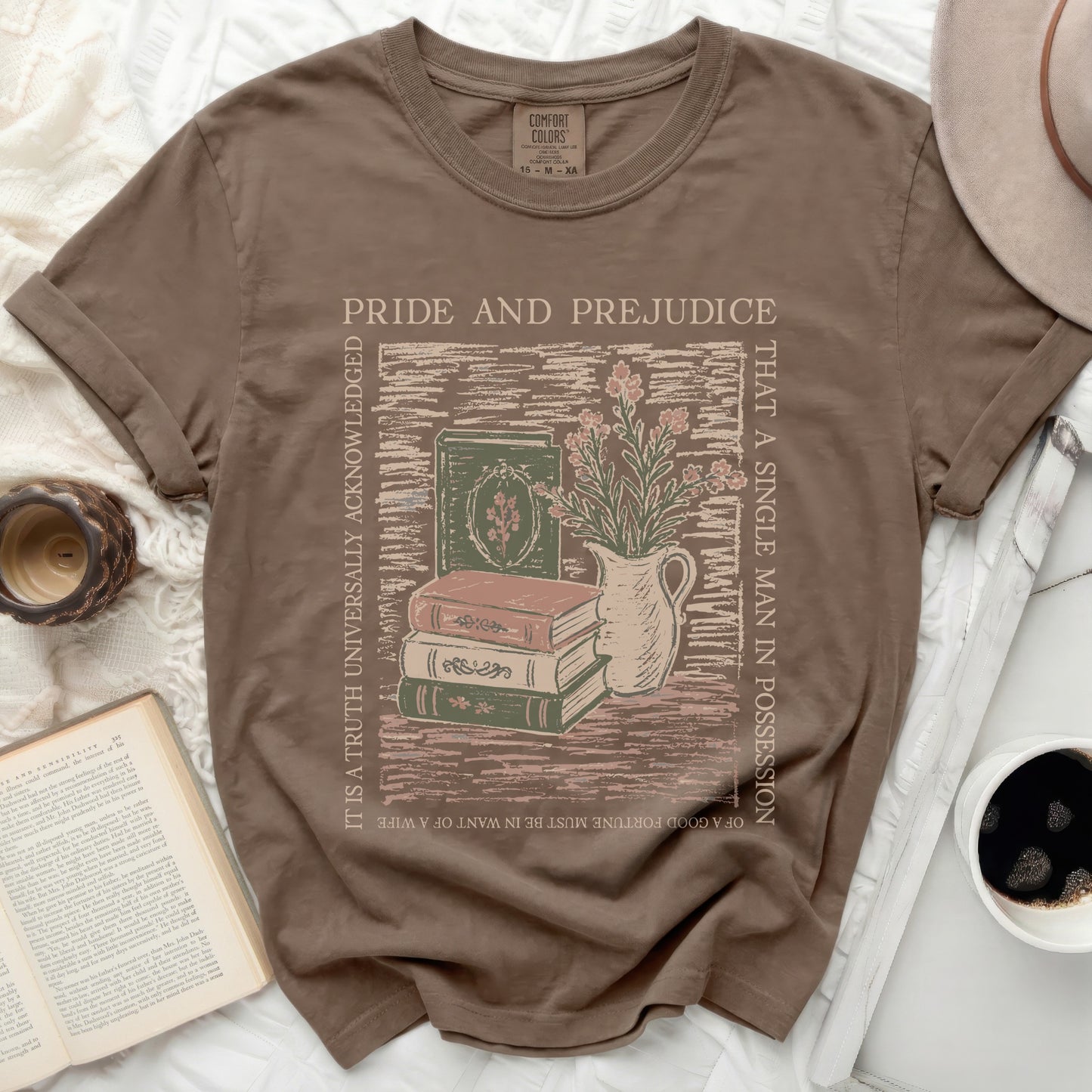 Brown t-shirt with Pride and Prejudice graphic of books and flowers.