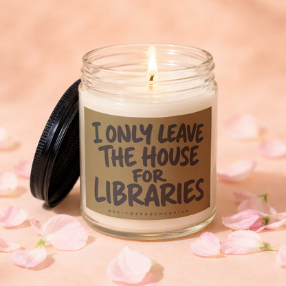 Candle with lit wick and black lid, reads "I ONLY LEAVE THE HOUSE FOR LIBRARIES".