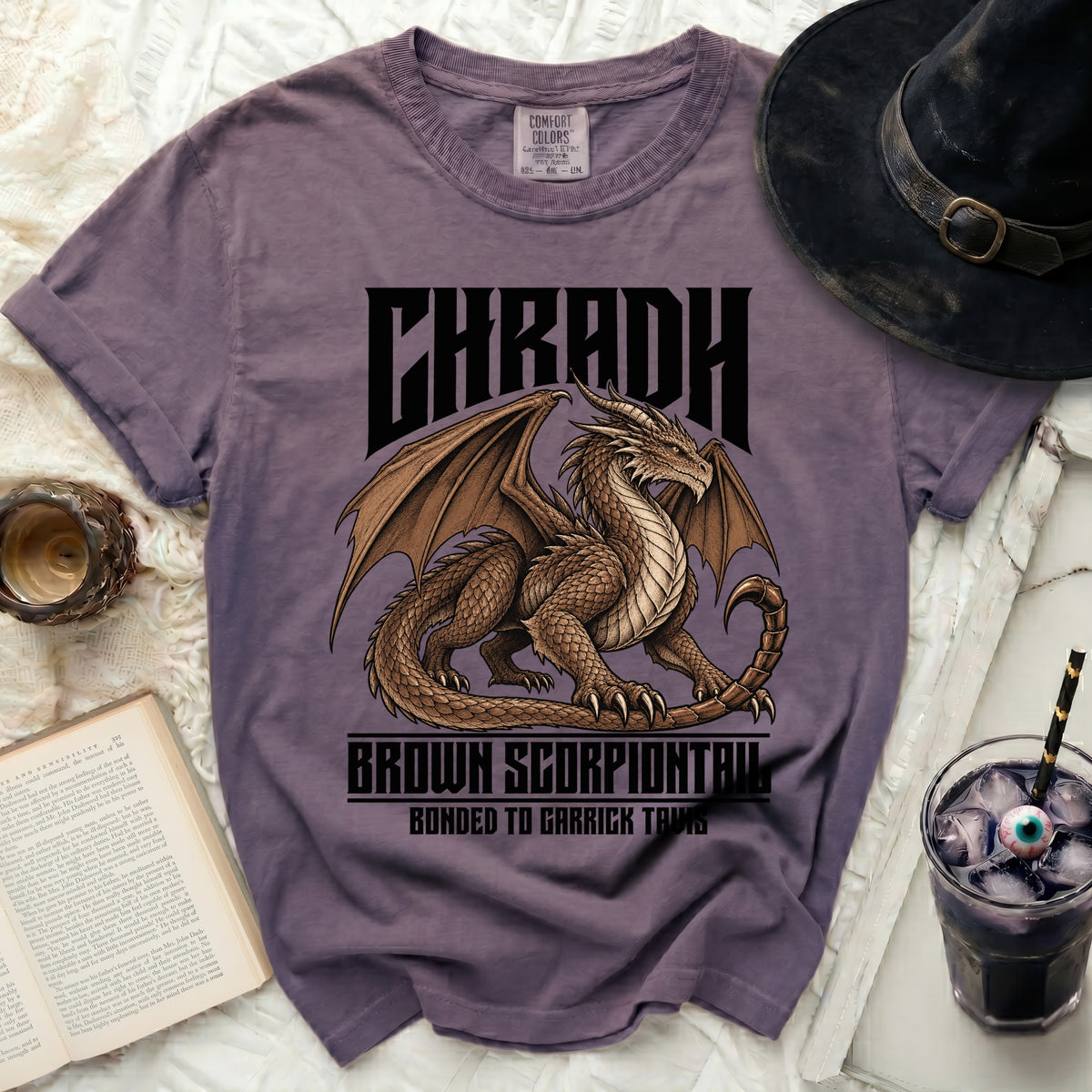 Purple t-shirt with a brown dragon and text "CHRADH BROWN SCORPIONTAIL BONDED TO GARRICK TAVIS".