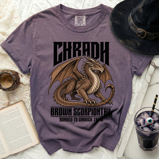 Purple t-shirt with a brown dragon and text "CHRADH BROWN SCORPIONTAIL BONDED TO GARRICK TAVIS".