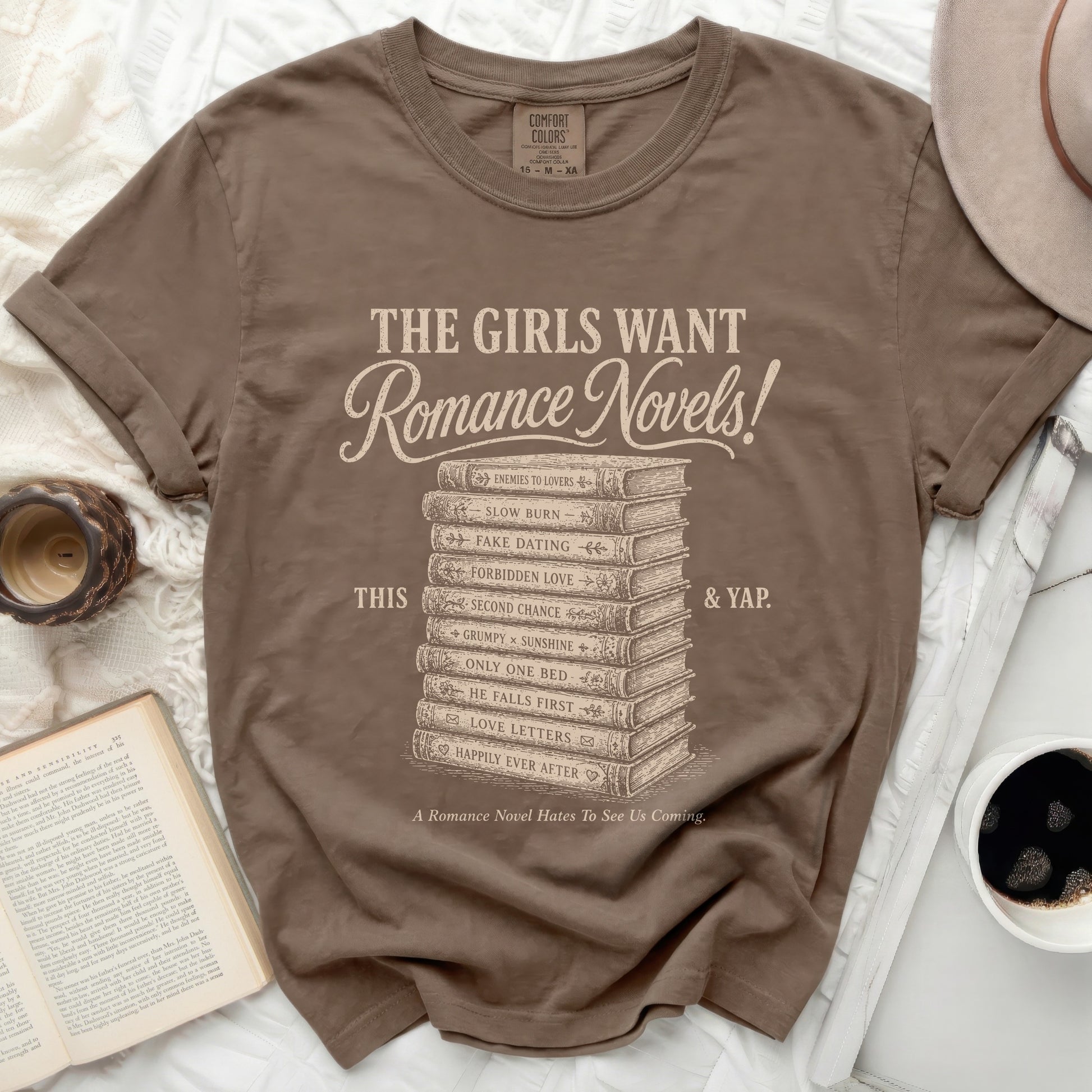 Brown t-shirt with "The Girls Want Romance Novels!" and romance tropes listed.