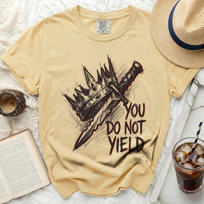 Yellow t-shirt with a crown and sword graphic and the text "YOU DO NOT YIELD".