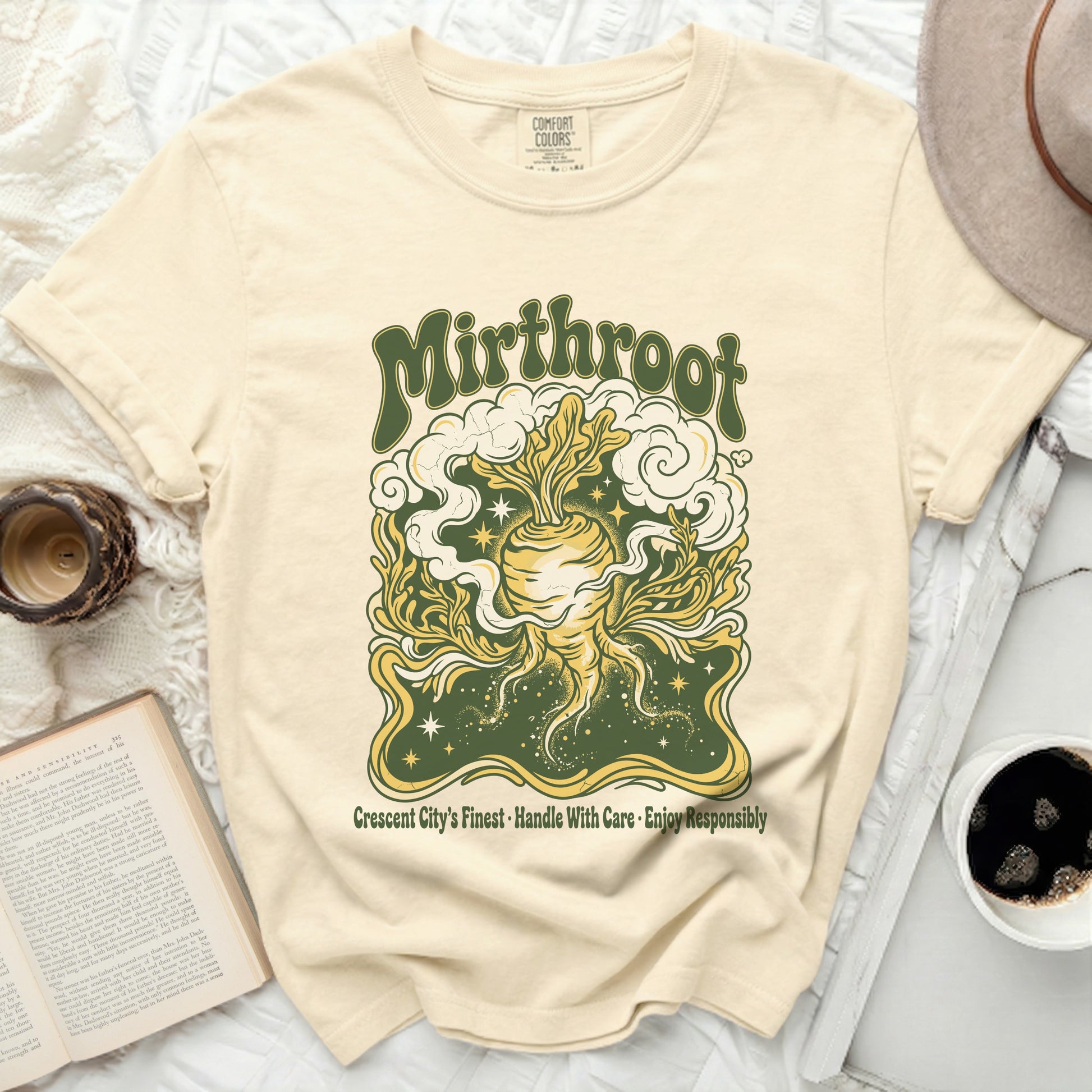 Cream t-shirt with "Mirthroot" and root vegetable design.