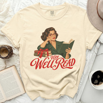 Cream t-shirt with "VERY Well READ" in red script, featuring a vintage woman reading.
