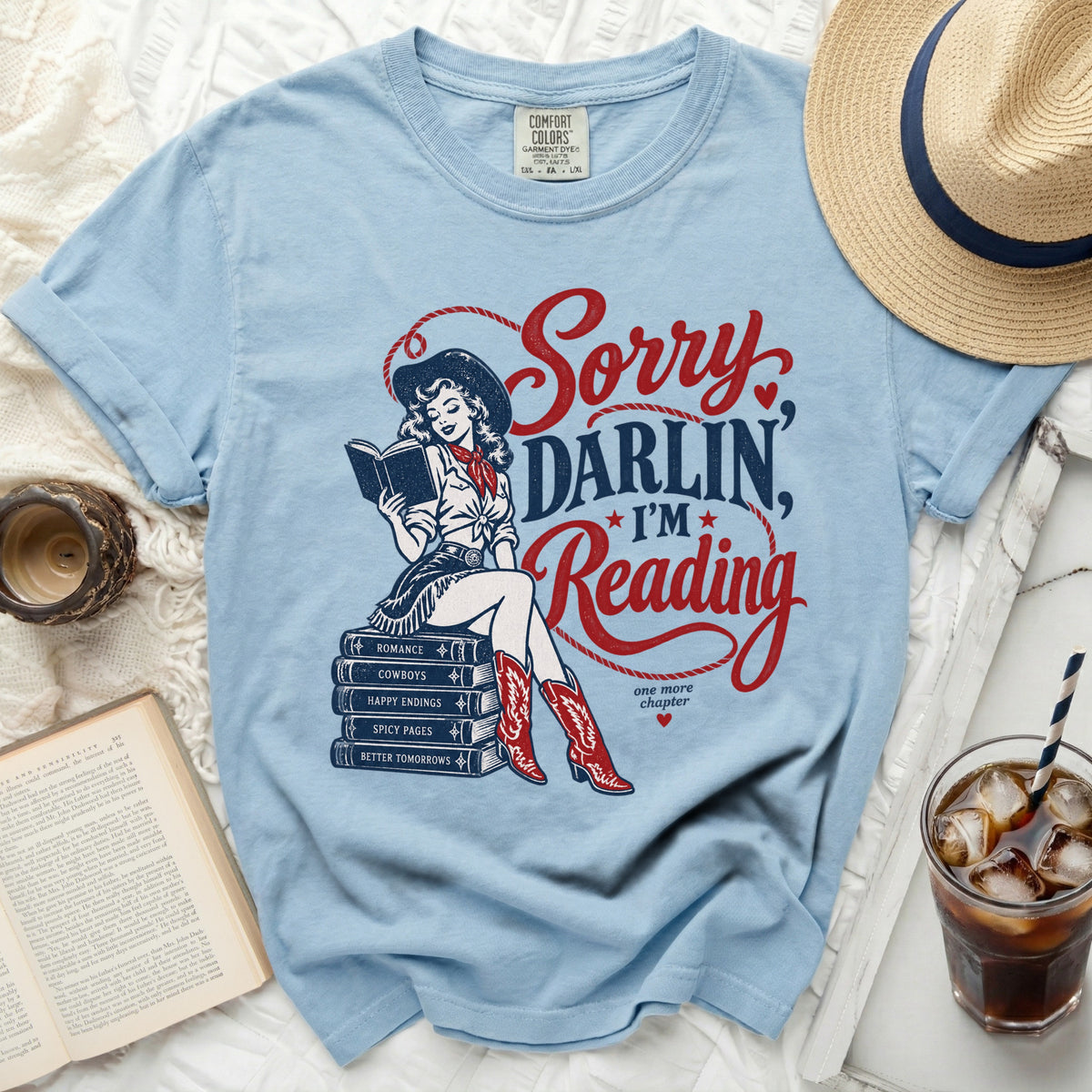 Light blue t-shirt with "Sorry Darlin, I'm Reading" and cowgirl graphic.