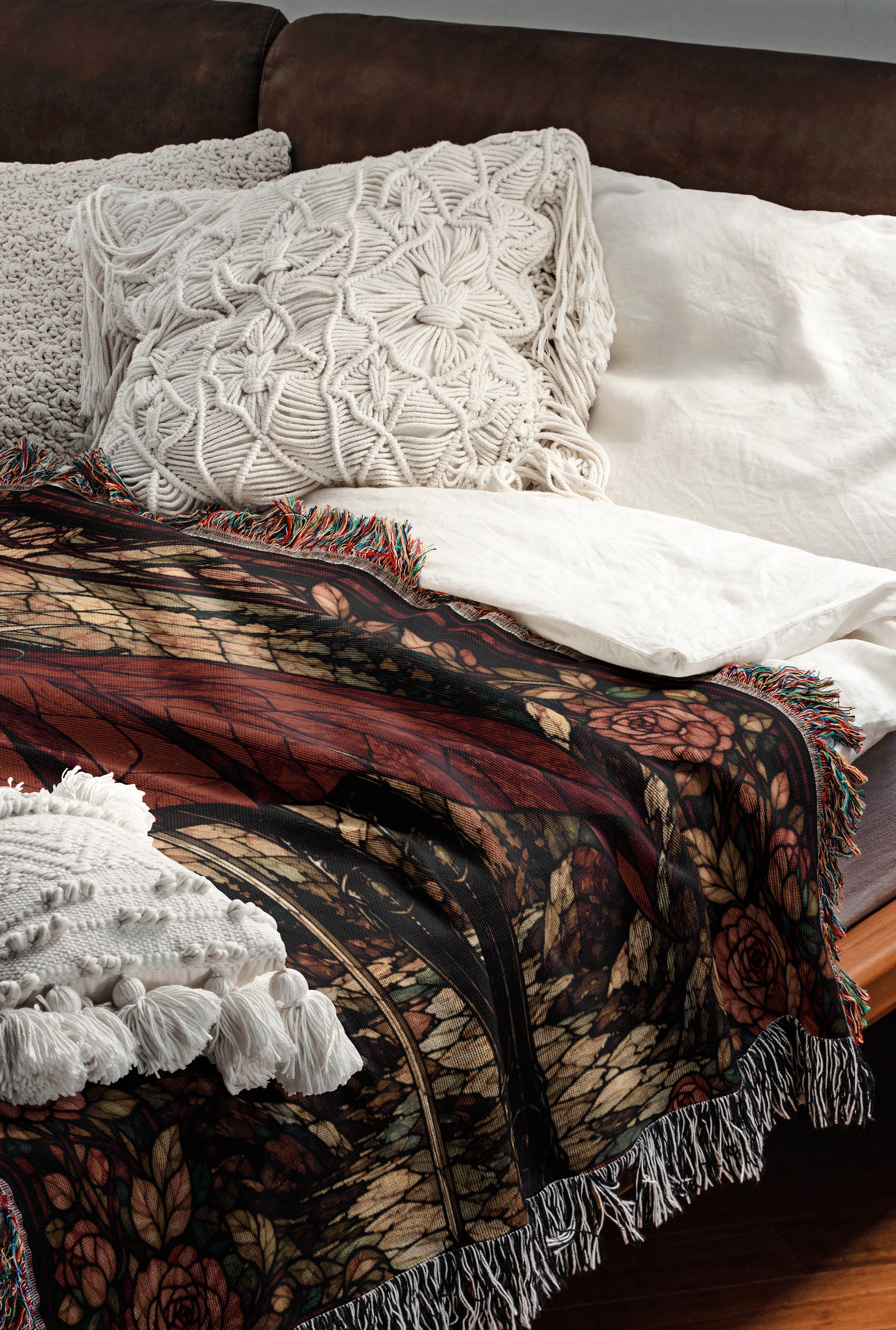 a cozy and inviting bedroom scene, featuring a bed with a colorful, patterned blanket and a white pillow. The bed is set against a brown leather headboard, creating a warm and comfortable atmosphere.
