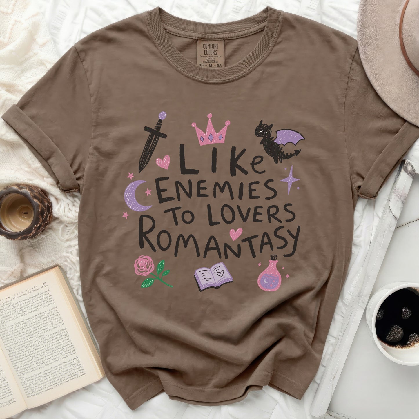 Brown t-shirt with "Like Enemies To Lovers Romantasy" graphic and fantasy icons.