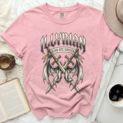 Pink t-shirt with "ILLYRIAN BLOOD RITE SURVIVOR" graphic and crossed swords.
