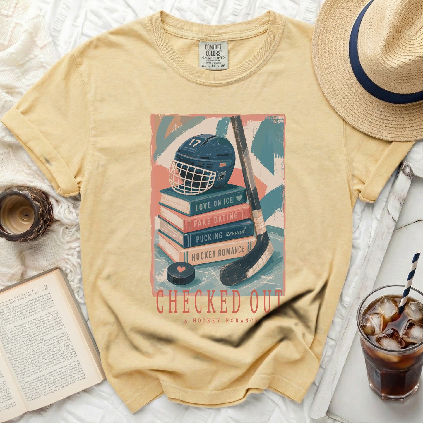 T-shirt with hockey books, helmet, and "Checked Out" text.