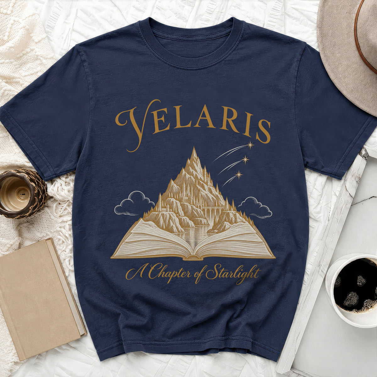 Navy t-shirt with "Velaris" and "A Chapter of Starlight" text, featuring a mountain city on an open book.