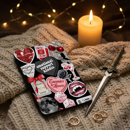 Kindle case with gothic stickers: hearts, lips, dice, and text.