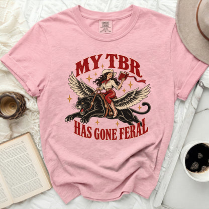 Pink Comfort Colors t-shirt with "My TBR Has Gone Feral" graphic of a woman on a winged panther.