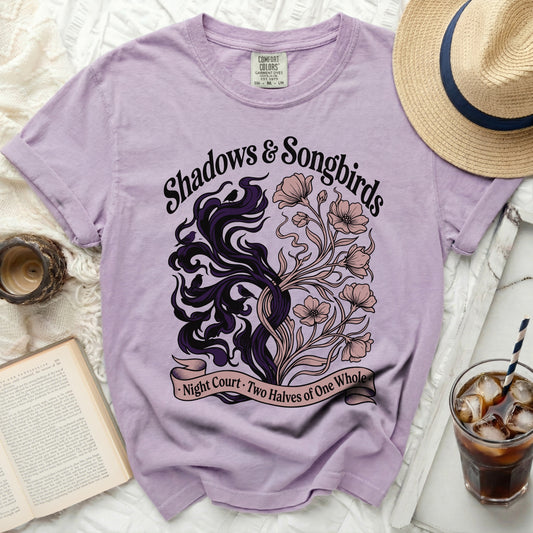 Purple t-shirt with "Shadows & Songbirds" and nature graphic.