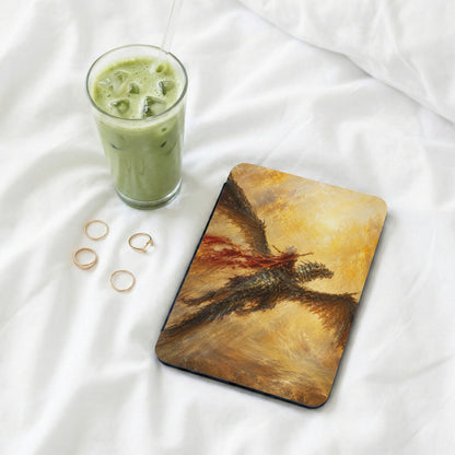 Tablet case with dragon art, a glass of matcha, and three gold rings.