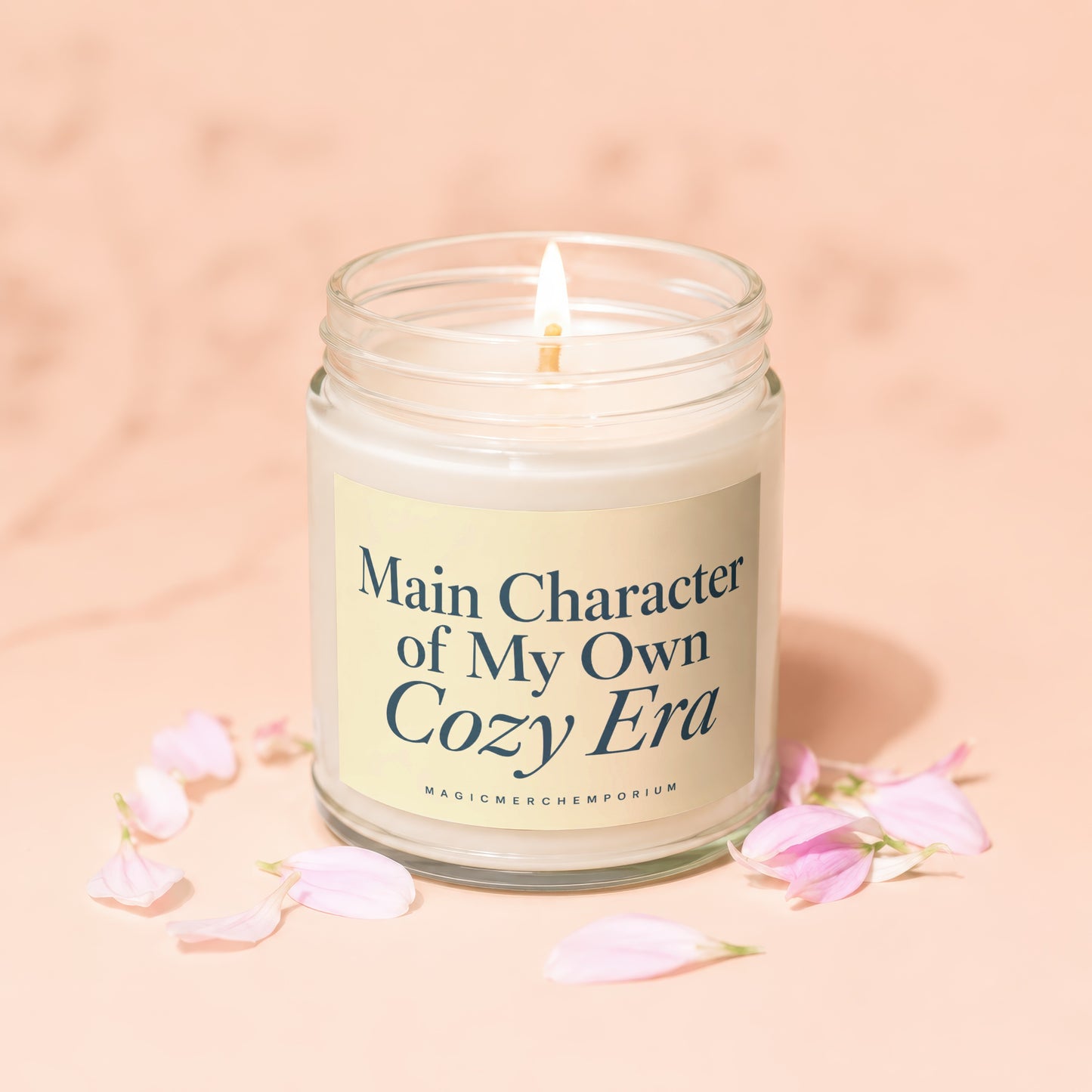 Lit candle in a glass jar with a yellow label reading "Main Character of My Own Cozy Era".