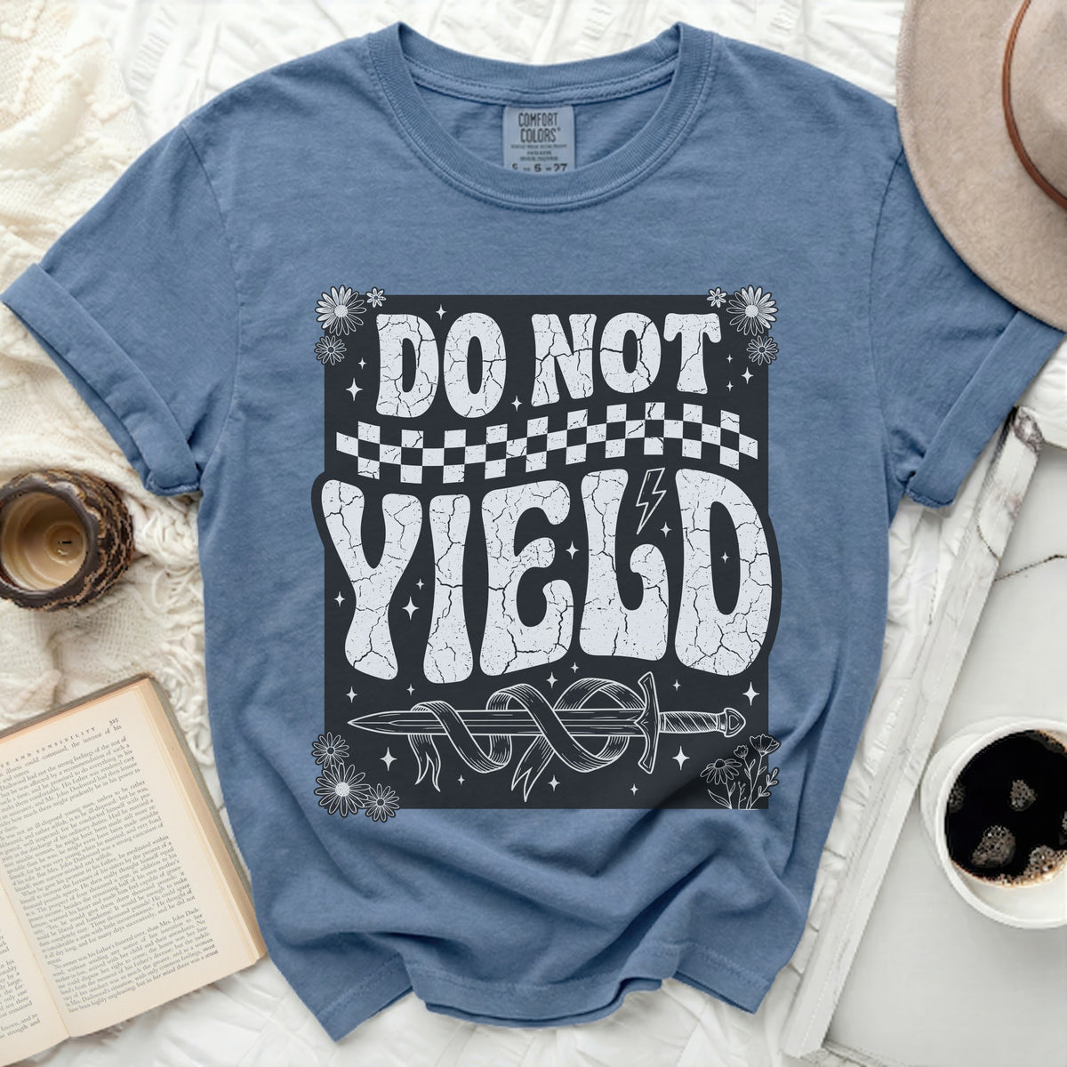 Blue t-shirt with "DO NOT YIELD" text, sword, and flowers design.