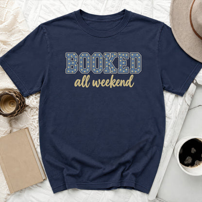 Navy t-shirt with "BOOKED all weekend" text in yellow and blue polka dots.