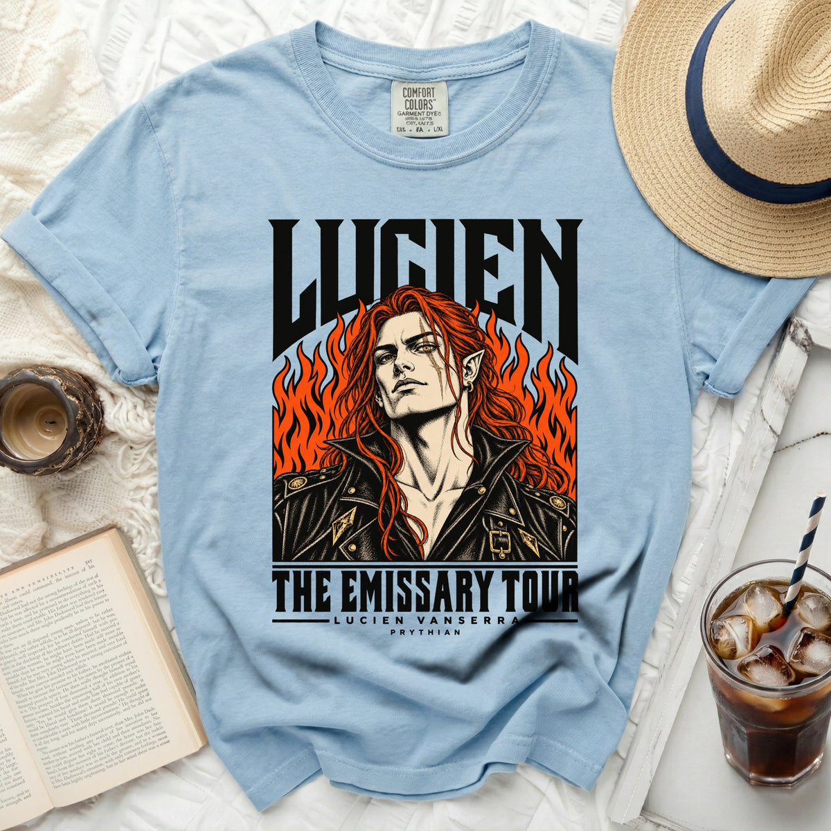 Light blue t-shirt with "LUCIEN THE EMISSARY TOUR" graphic.