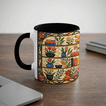 White mug with black handle featuring a stained glass shelf design with books and flowers.