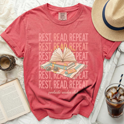 Red t-shirt with "REST, READ, REPEAT poolside reader club" text.