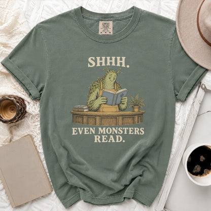 Green t-shirt with "SHHH. EVEN MONSTERS READ." graphic of a monster reading.