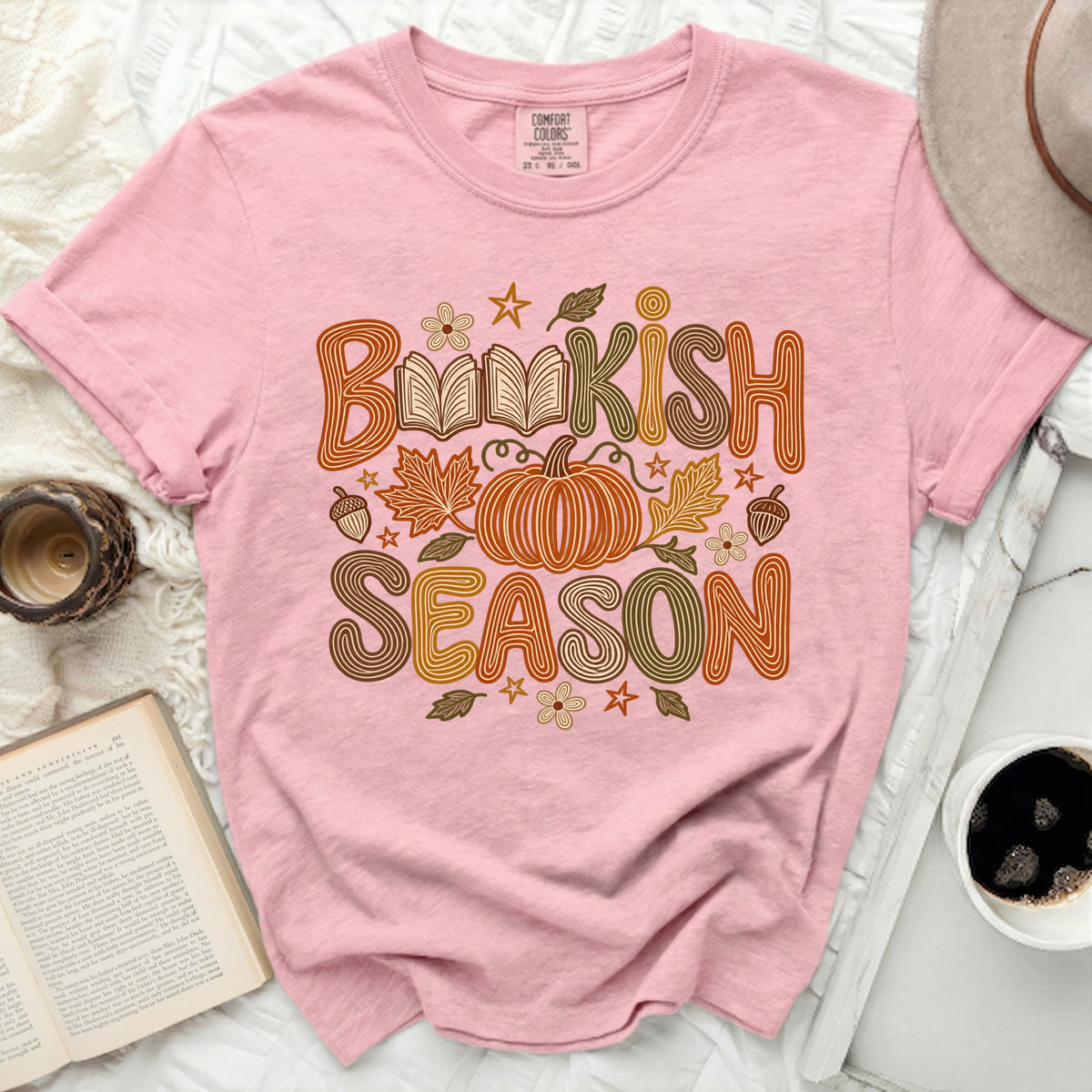 Pink t-shirt with "Bookish Season" text, pumpkin, and fall leaves graphic.