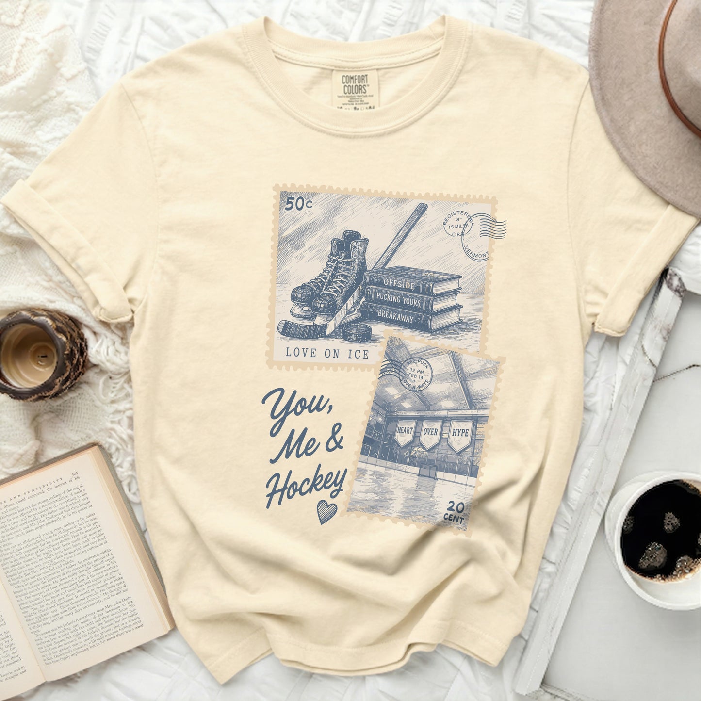 Cream t-shirt with vintage hockey and book graphic and text.