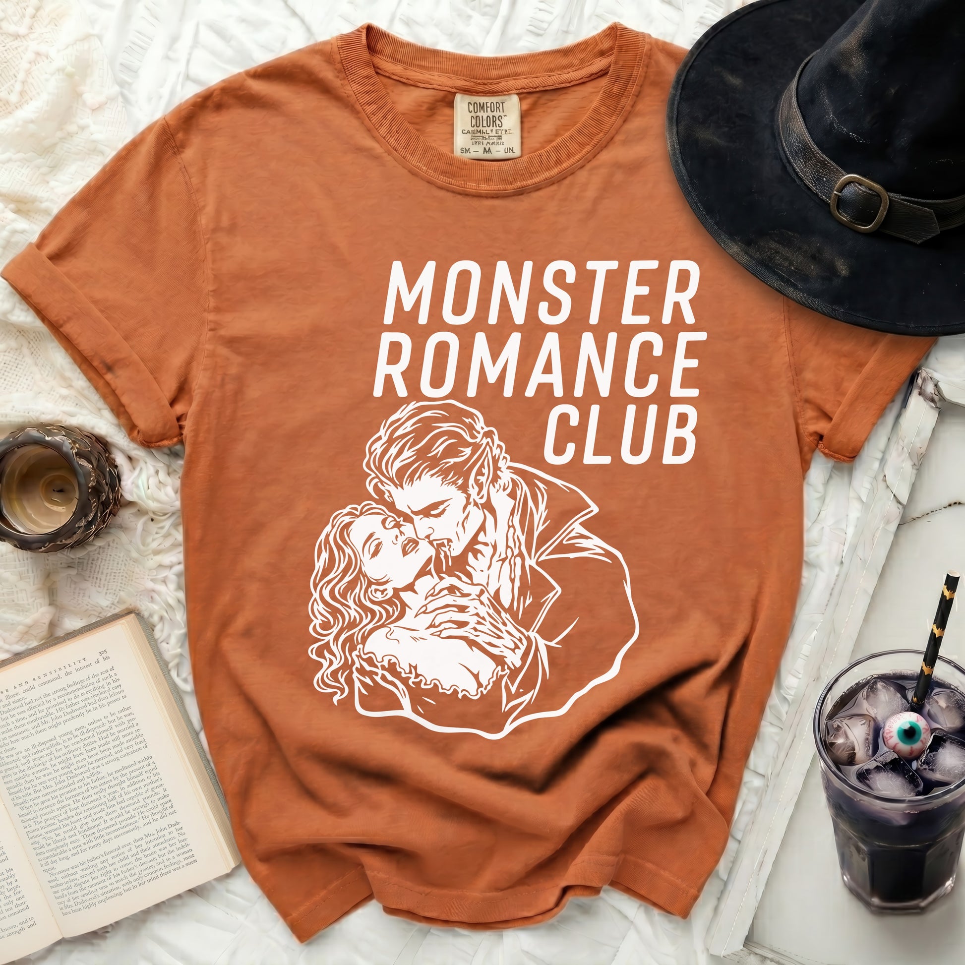 Orange Comfort Colors t-shirt with "Monster Romance Club" graphic.
