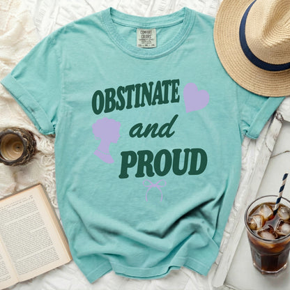 Teal t-shirt with "OBSTINATE and PROUD" text and purple graphics.