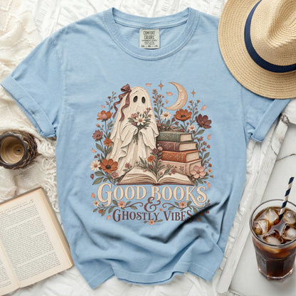 Light blue t-shirt with ghost, books, moon, and floral graphic reading "Good Books & Ghostly Vibes".