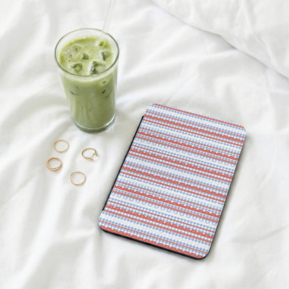 Patterned tablet case with rings and iced coffee nearby