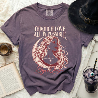 Purple t-shirt with "Through Love All is Possible Bryce Quinlan" text and celestial art.