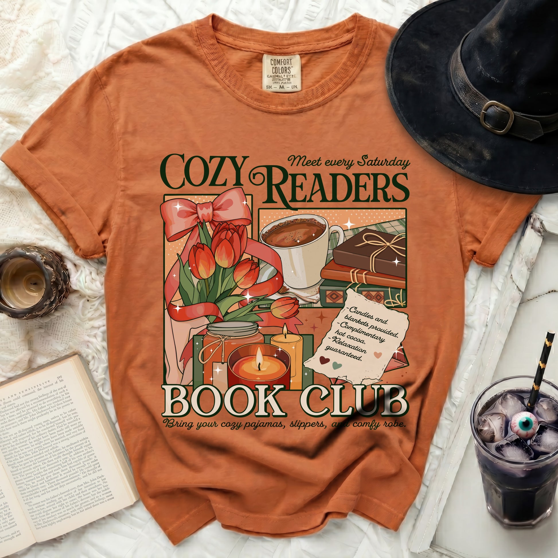 Orange t-shirt with "Cozy Readers Book Club" graphic, tulips, coffee, and candles.