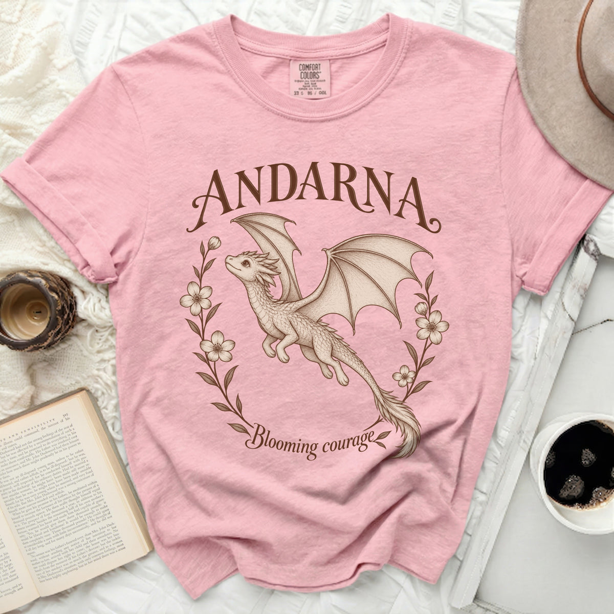 Pink t-shirt with "ANDARNA" and a dragon design with "Blooming courage".