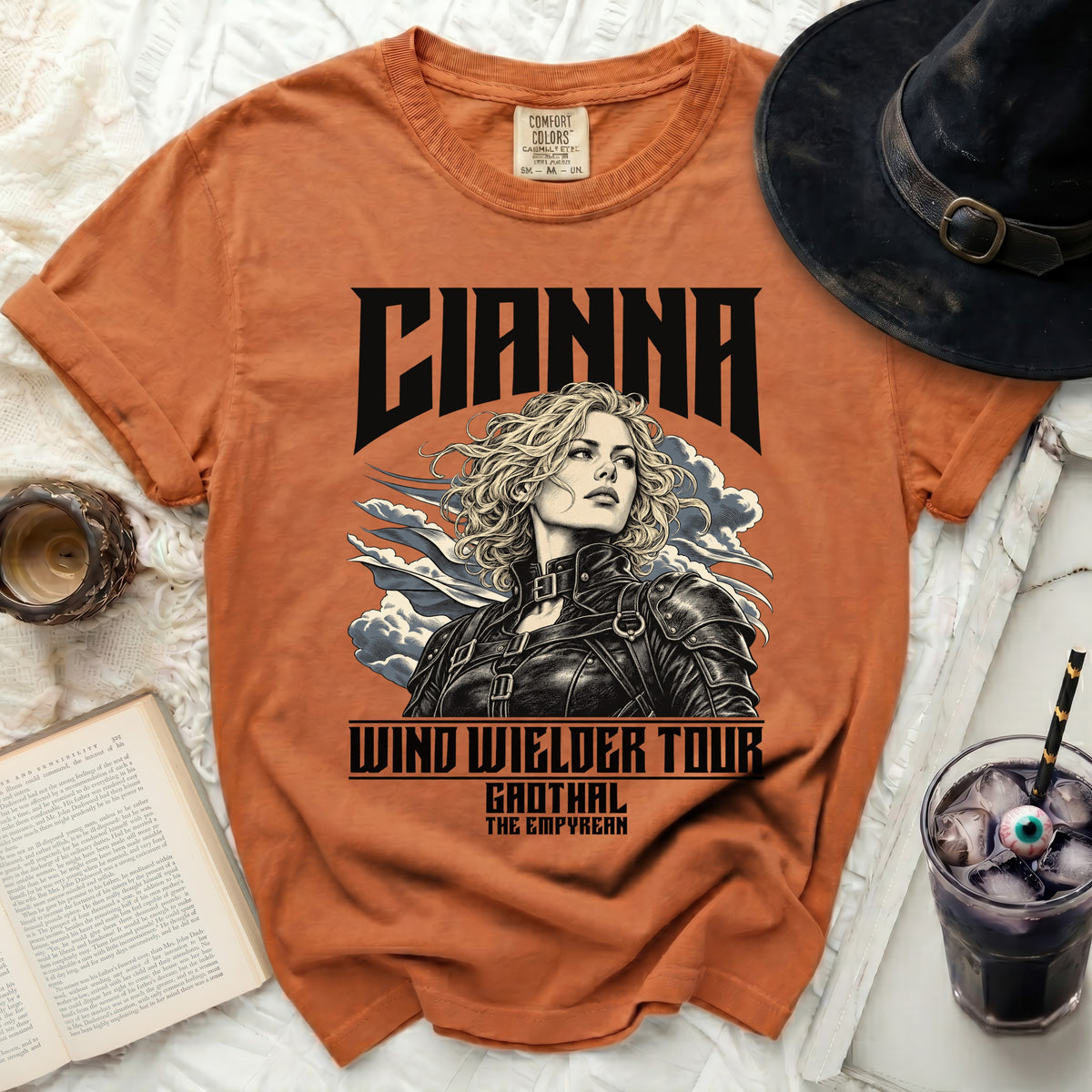 Orange t-shirt featuring "CIANNA WIND WIELDER TOUR" and a woman.