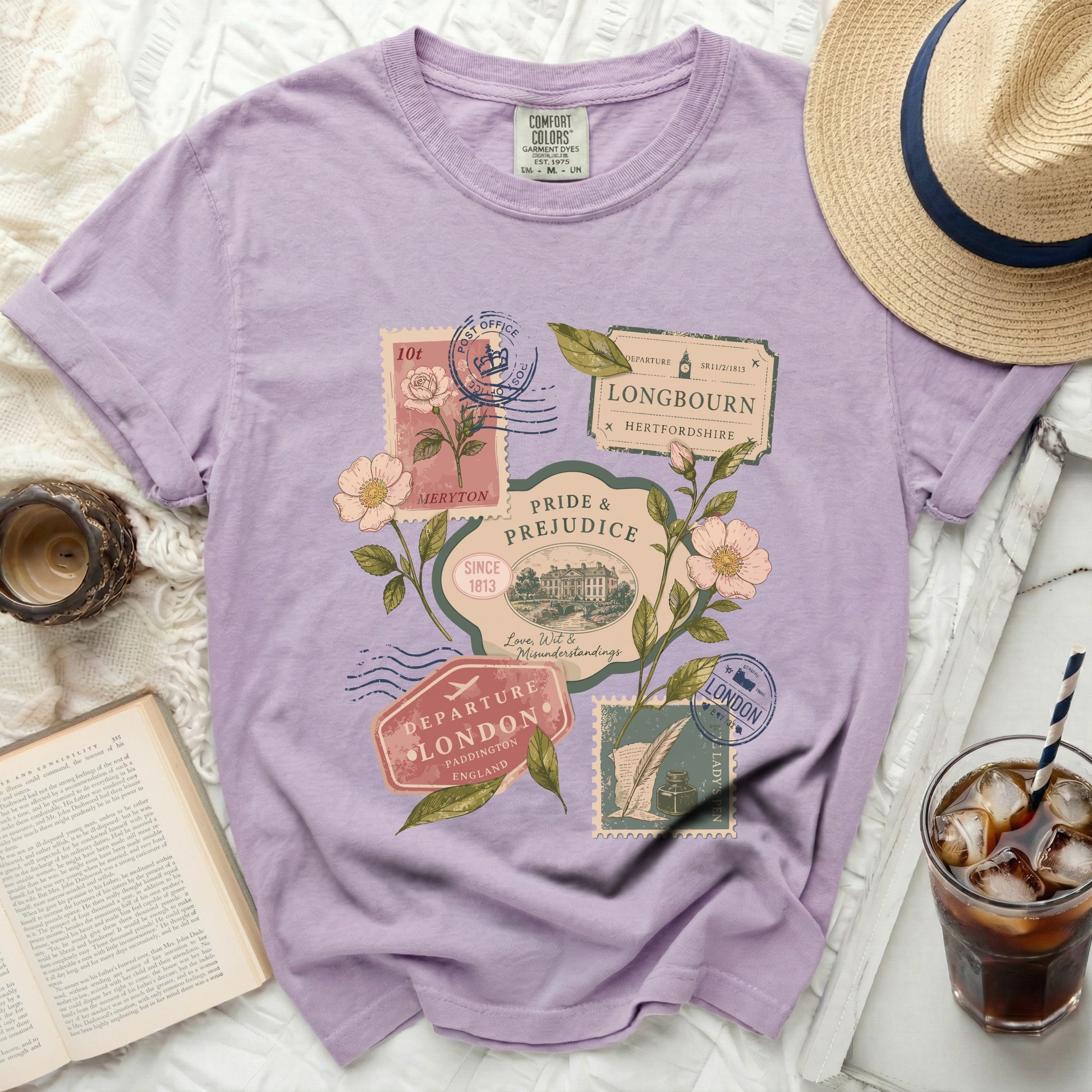 Purple t-shirt with vintage travel stamps and floral graphics.