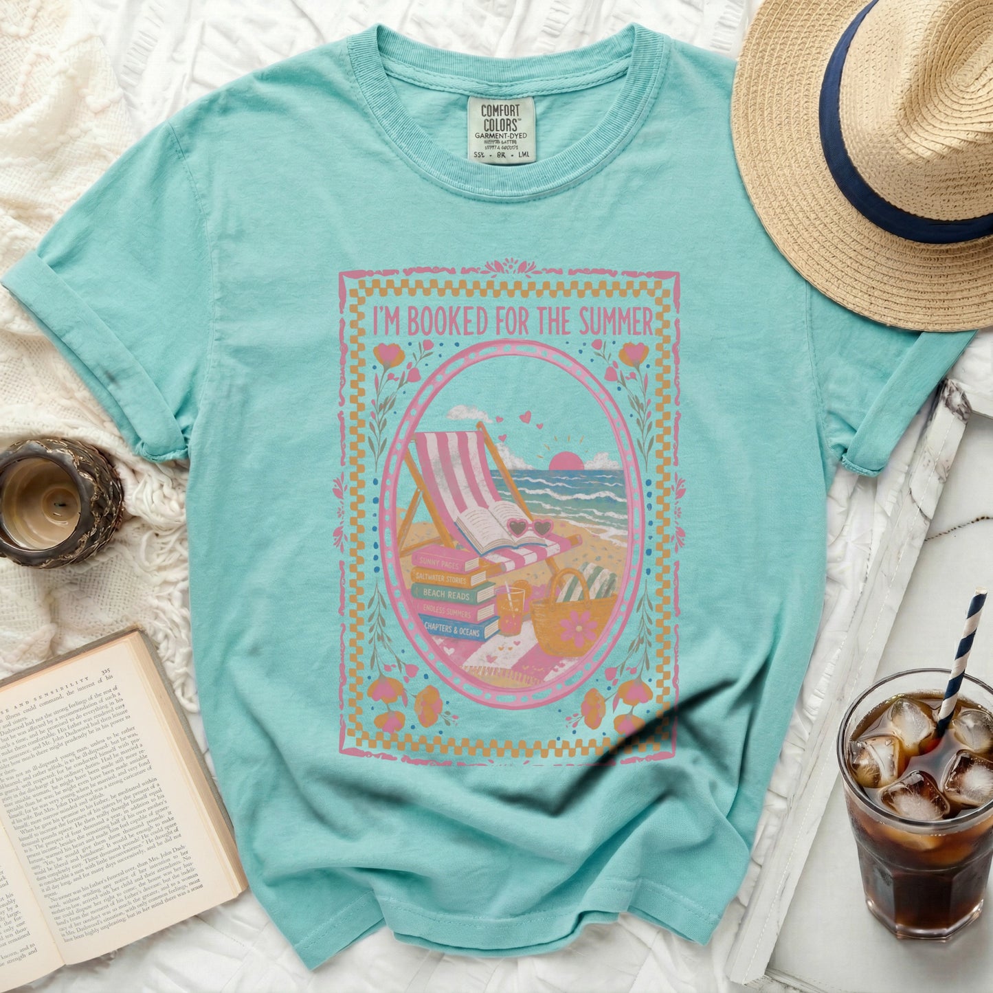 Teal t-shirt with "I'M BOOKED FOR THE SUMMER" graphic and beach scene.
