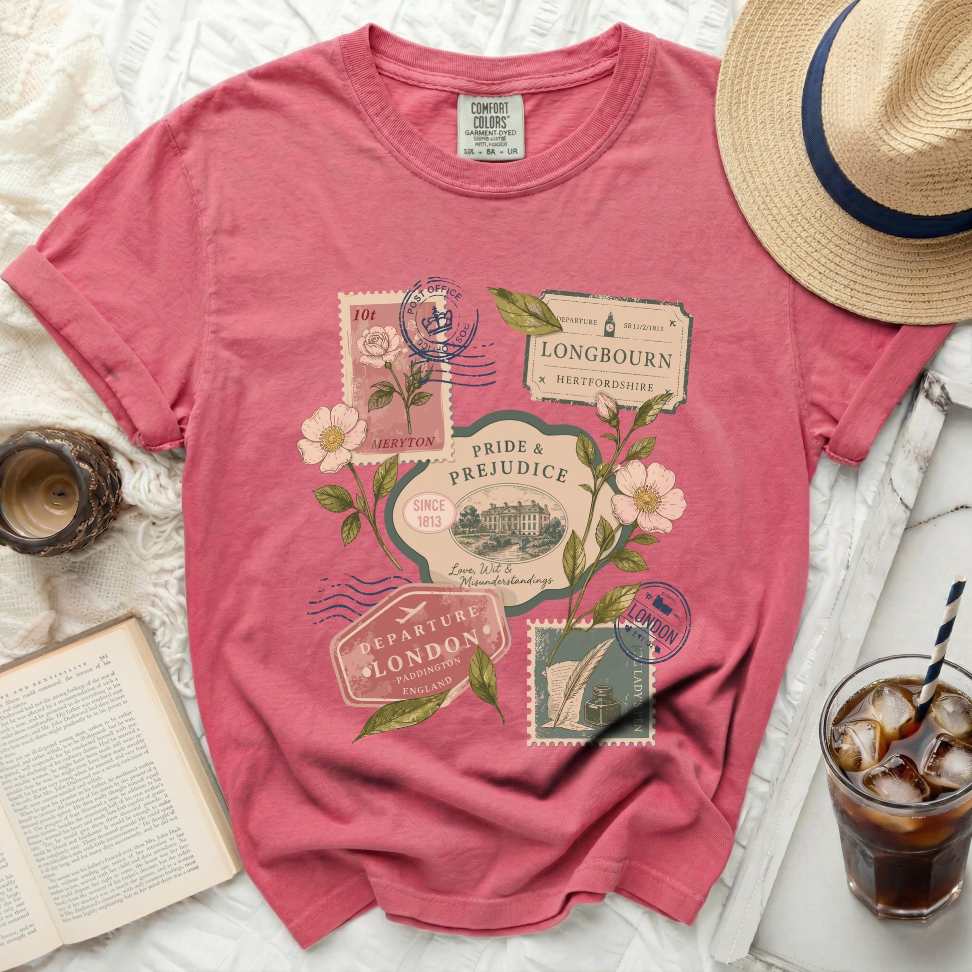 Pink t-shirt with "Pride and Prejudice" stamp graphics and floral accents.