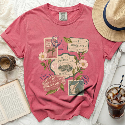 Pink t-shirt with "Pride and Prejudice" stamp graphics and floral accents.