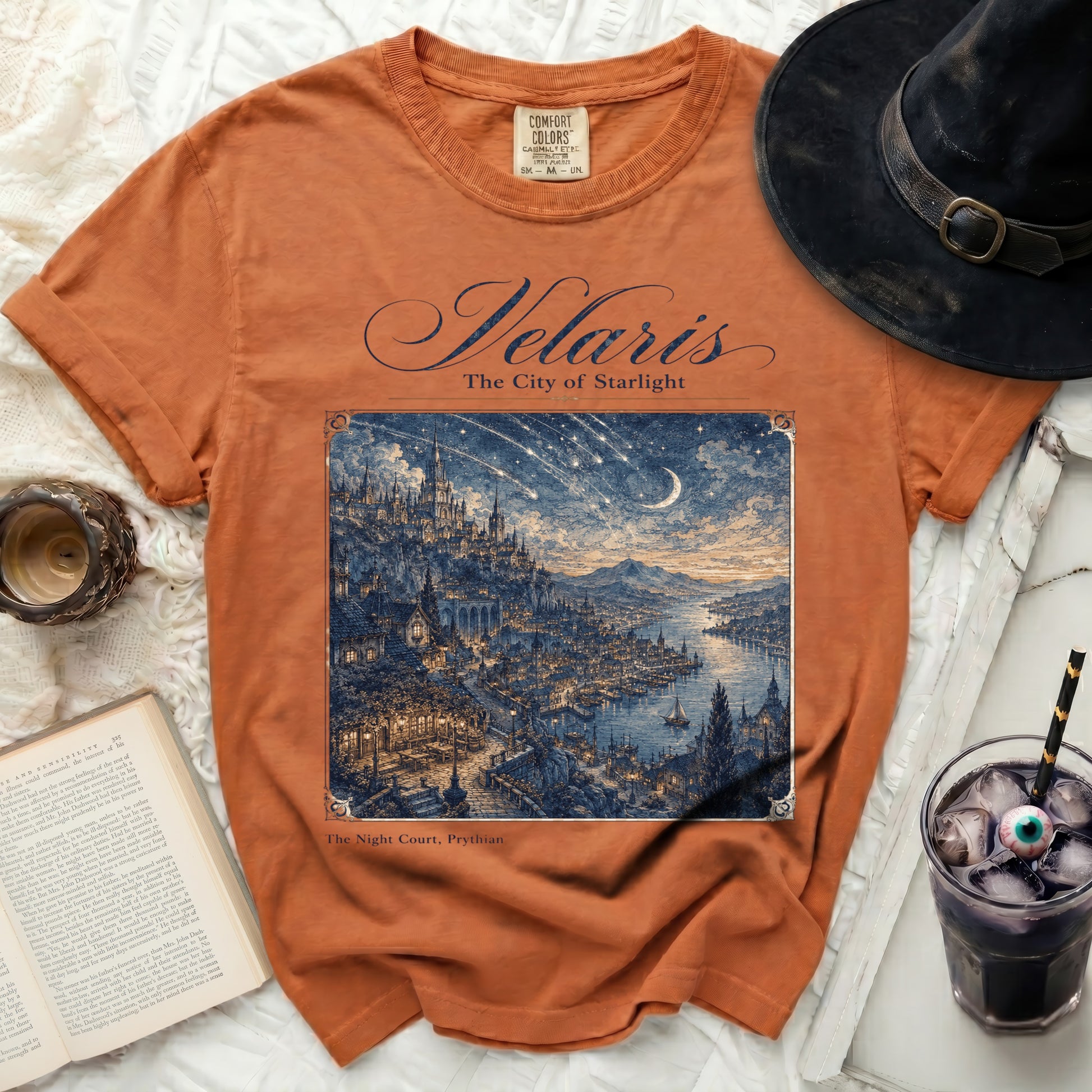 Orange t-shirt with "Velaris The City of Starlight" and detailed city illustration.