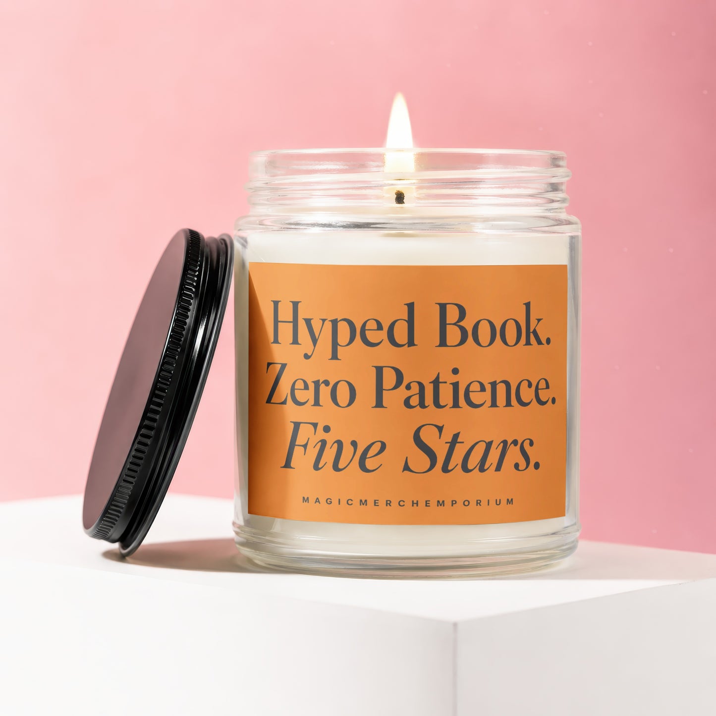 Candle with "Hyped Book. Zero Patience. Five Stars." text on orange label.