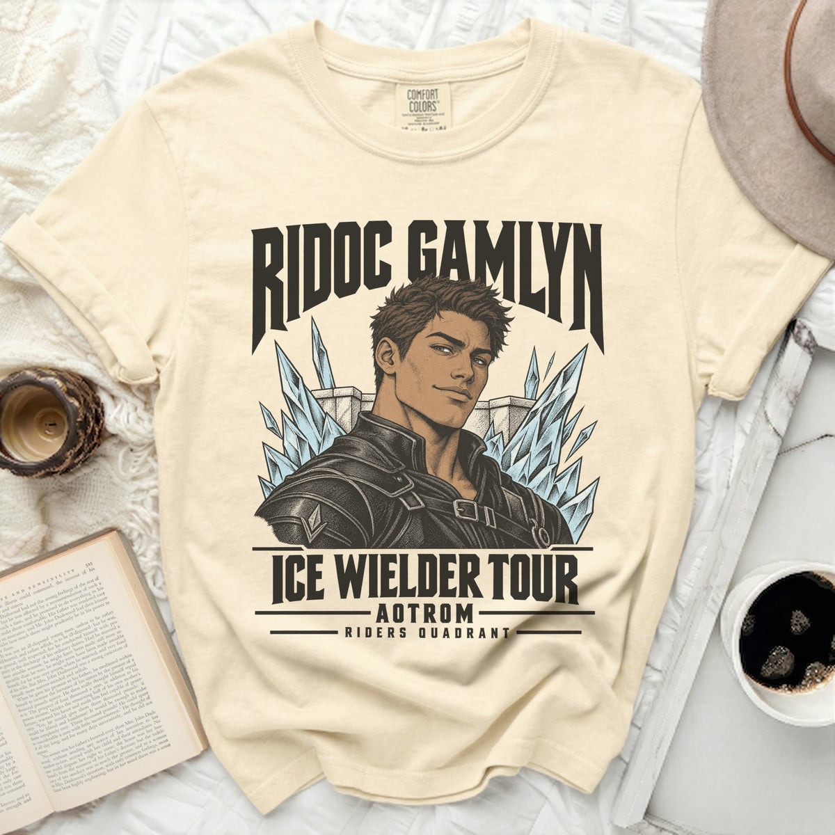 Cream t-shirt with a graphic of a male character and the text "RIDOC GAMLYN ICE WIELDER TOUR AOTROM RIDERS QUADRANT".