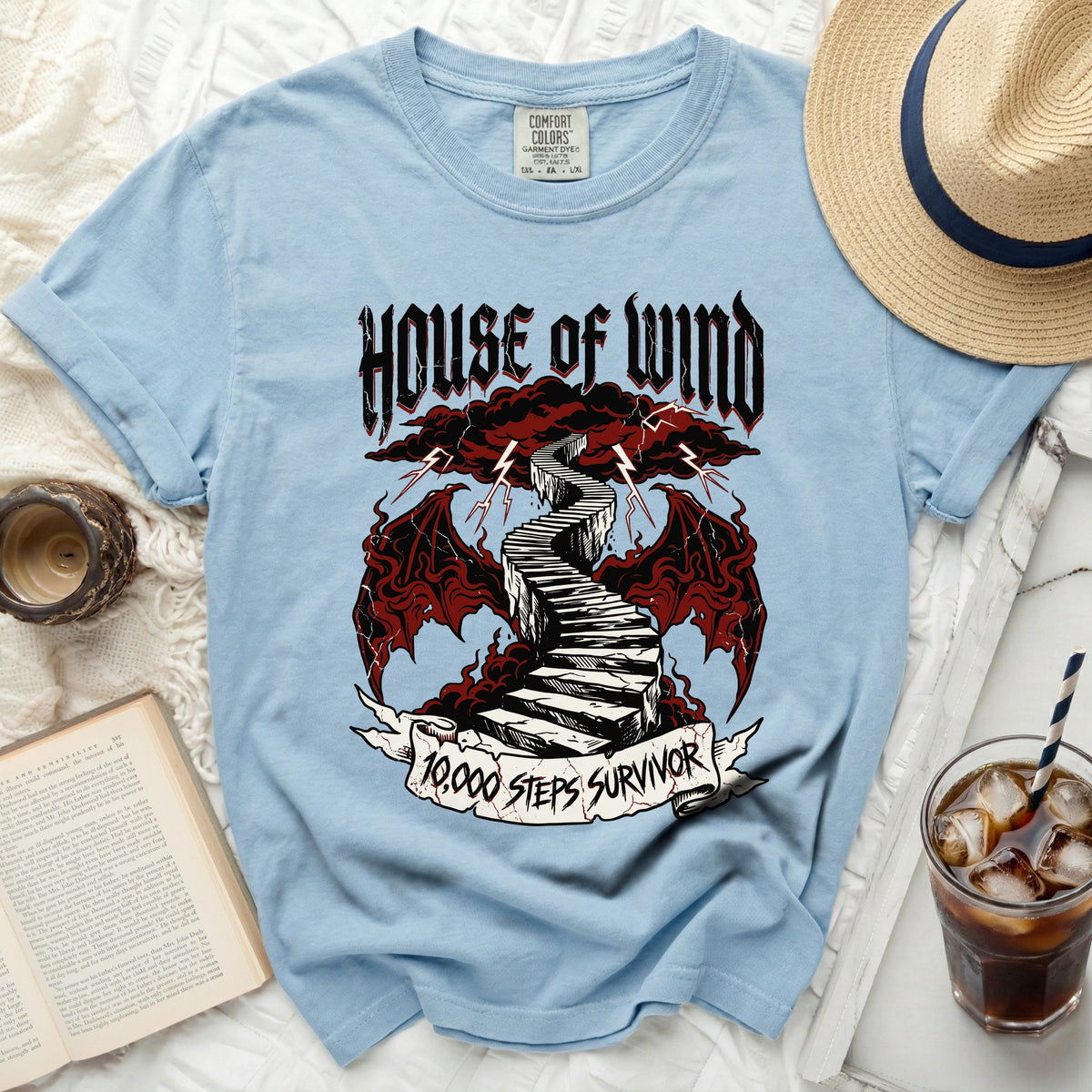 Light blue t-shirt with "House of Wind" and "10,000 Steps Survivor" graphics.