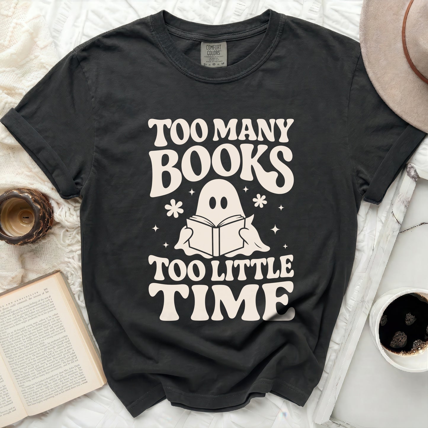 Black t-shirt with "TOO MANY BOOKS TOO LITTLE TIME" and a ghost reading a book.