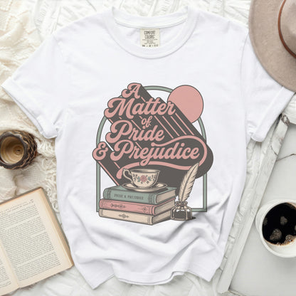White t-shirt with "A Matter of Pride & Prejudice" graphic and books.